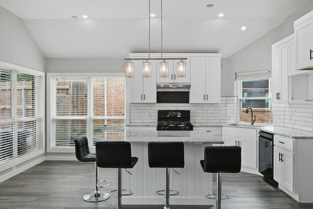 2528 Forestwood Dr, Flower Mound, TX 75028 - kitchen featuring stove, vaulted ceiling, black dishwasher, under cabinet range hood, and light stone counters