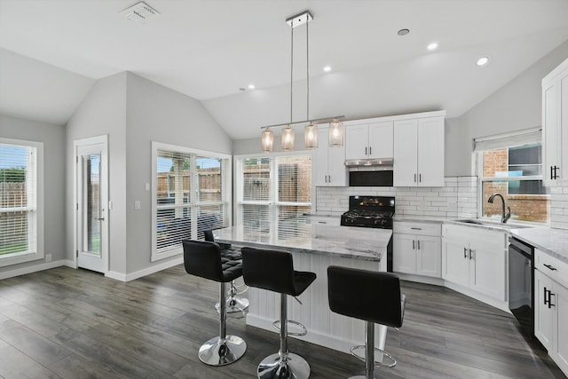 2528 Forestwood Dr, Flower Mound, TX 75028 - kitchen with black gas range oven, lofted ceiling, dishwasher, backsplash, and light stone counters