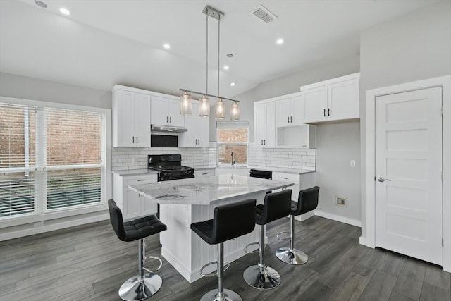 2528 Forestwood Dr, Flower Mound, TX 75028 - kitchen with black range with gas cooktop, backsplash, white cabinetry, under cabinet range hood, and recessed lighting