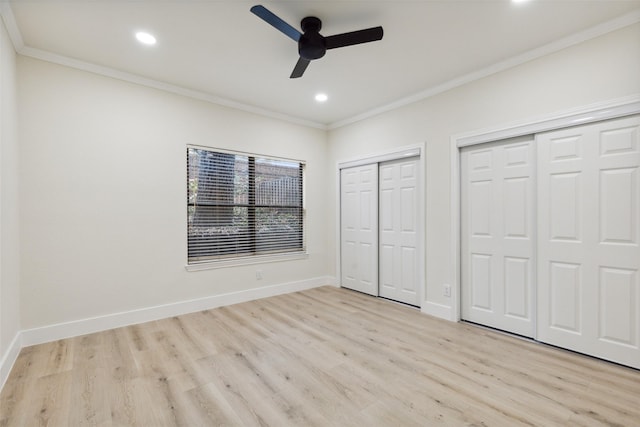7340 Skillman St Unit 107, Dallas, TX 75231 - unfurnished bedroom featuring two closets, light wood-type flooring, crown molding, recessed lighting, and a ceiling fan