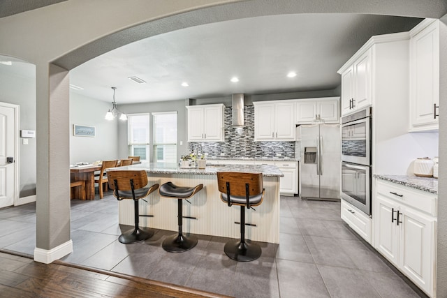 1017 Appalachian Ln, Savannah, TX 76227 - kitchen with stainless steel appliances, wall chimney range hood, tasteful backsplash, light stone counters, and recessed lighting