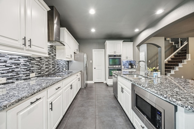 1017 Appalachian Ln, Savannah, TX 76227 - kitchen with stainless steel appliances, wall chimney exhaust hood, backsplash, white cabinets, and recessed lighting