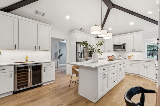 810 Quail Run, Keller, TX 76248 - kitchen with stainless steel appliances, wine cooler, decorative backsplash, white cabinets, and recessed lighting