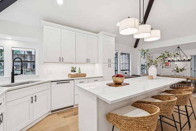 810 Quail Run, Keller, TX 76248 - kitchen featuring light wood finished floors, light stone countertops, recessed lighting, a breakfast bar, and a kitchen island