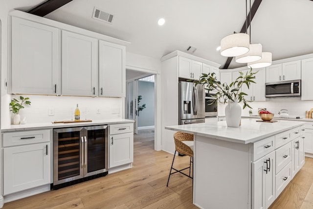 810 Quail Run, Keller, TX 76248 - kitchen with wine cooler, stainless steel appliances, backsplash, white cabinetry, and recessed lighting