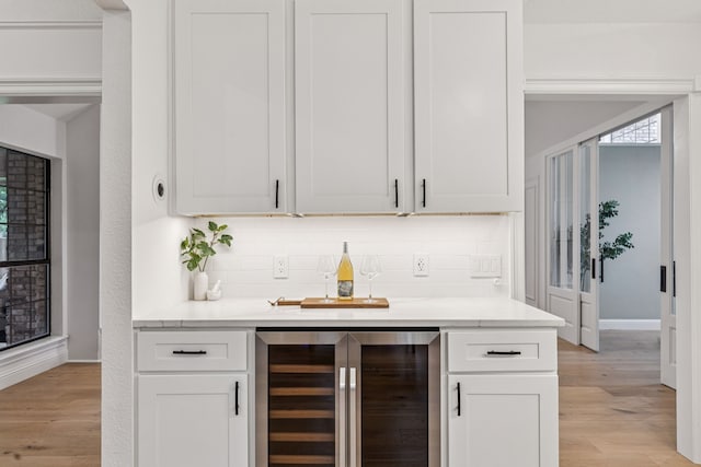810 Quail Run, Keller, TX 76248 - bar area with wine cooler, tasteful backsplash, and light wood-type flooring