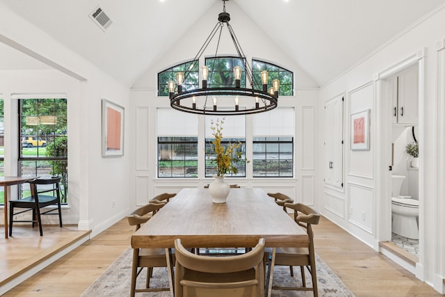 810 Quail Run, Keller, TX 76248 - dining area featuring a chandelier, vaulted ceiling, healthy amount of natural light, and light wood-style flooring
