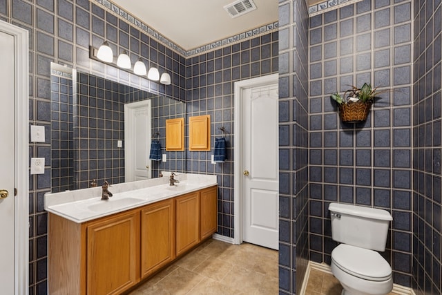495 Bending Oaks Trl, Rockwall, TX 75087 - bathroom with tile patterned floors, double vanity, and tile walls