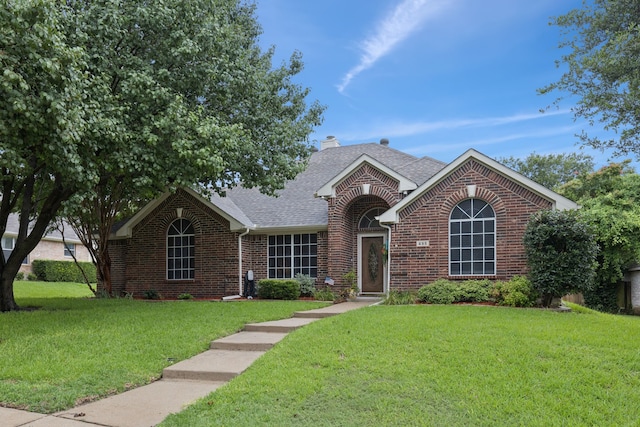 495 Bending Oaks Trl, Rockwall, TX 75087 - view of front of house with brick siding, a front yard, roof with shingles, and a chimney