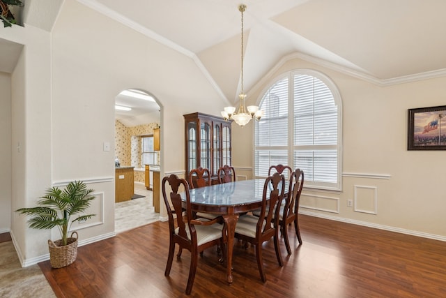 495 Bending Oaks Trl, Rockwall, TX 75087 - dining room with a chandelier, dark wood-style floors, arched walkways, wainscoting, and lofted ceiling