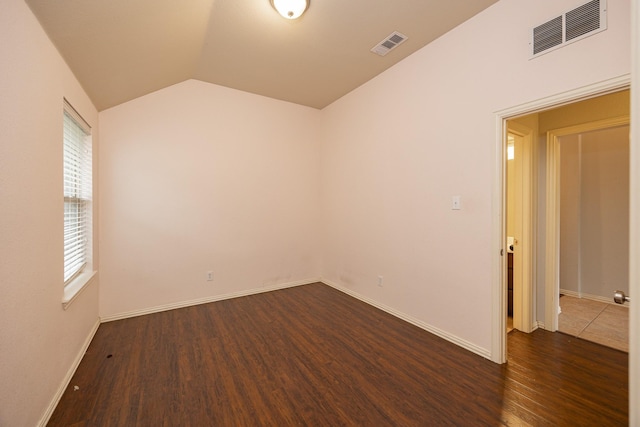 2111 Rains County Rd, Forney, TX 75126 - spare room with vaulted ceiling and dark wood-style flooring