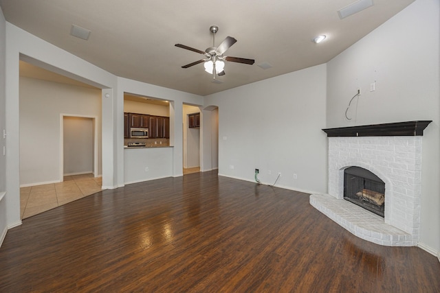 2111 Rains County Rd, Forney, TX 75126 - unfurnished living room with a ceiling fan, wood finished floors, and a fireplace