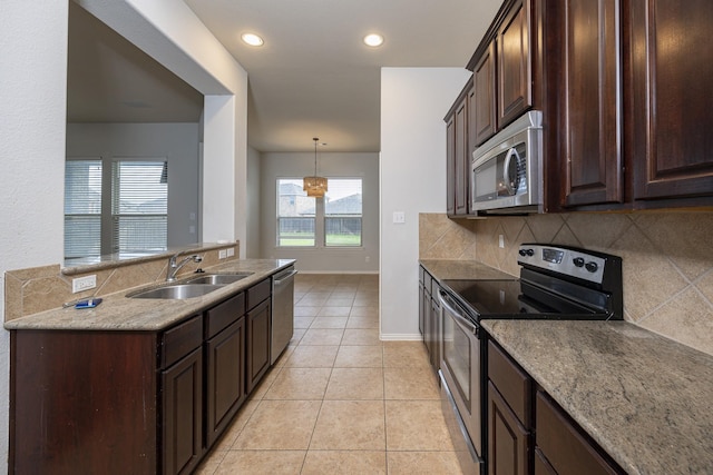 2111 Rains County Rd, Forney, TX 75126 - kitchen with stainless steel appliances, tasteful backsplash, dark brown cabinets, light tile patterned floors, and light stone counters