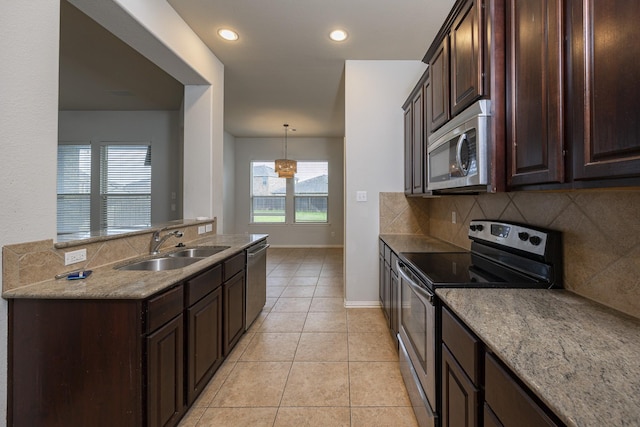 2111 Rains County Rd, Forney, TX 75126 - kitchen featuring appliances with stainless steel finishes, tasteful backsplash, dark brown cabinets, light tile patterned floors, and recessed lighting