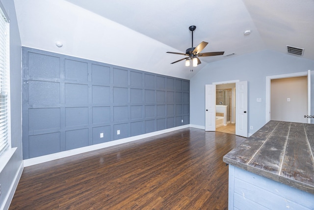 2111 Rains County Rd, Forney, TX 75126 - unfurnished living room featuring a decorative wall, a ceiling fan, wood finished floors, and vaulted ceiling