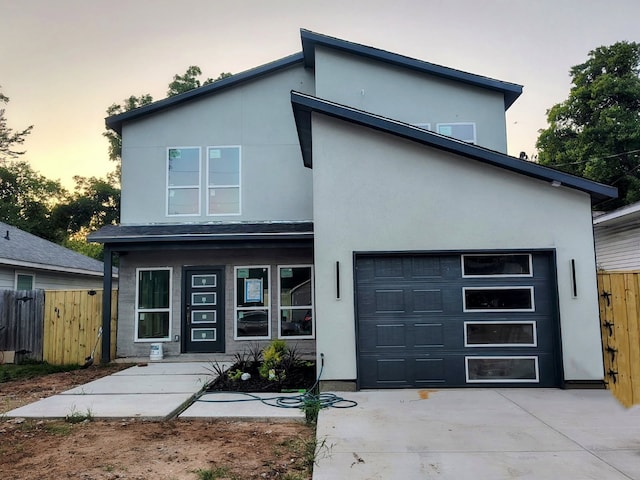 2417 Felton Ct, Dallas, TX 75215 - contemporary home with driveway, an attached garage, and stucco siding