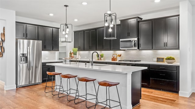 2015 Partridge Rd, Princeton, TX 75407 - kitchen with stainless steel appliances, recessed lighting, an island with sink, light countertops, and backsplash