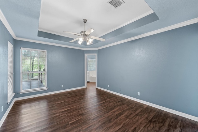 519 Kristi St, Robinson, TX 76706 - spare room featuring a tray ceiling, plenty of natural light, dark wood finished floors, and crown molding