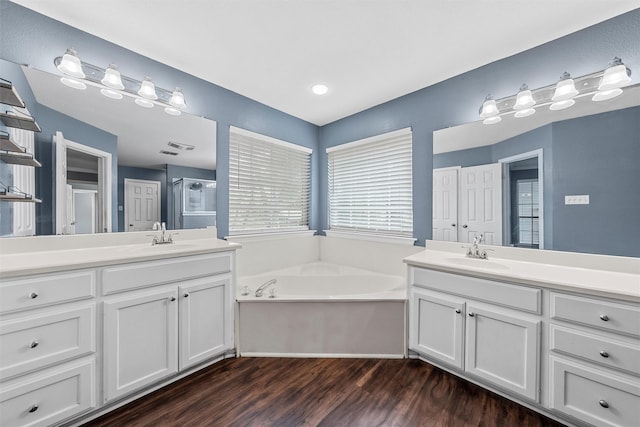519 Kristi St, Robinson, TX 76706 - full bathroom featuring two vanities, a bath, wood finished floors, and a shower stall