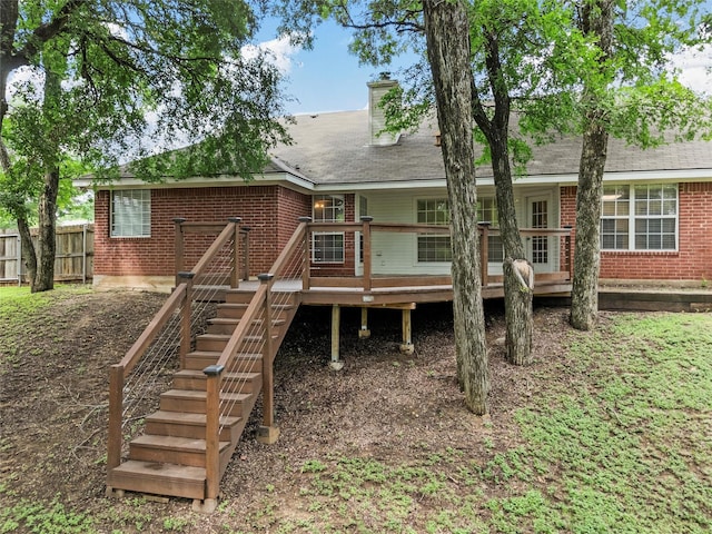 519 Kristi St, Robinson, TX 76706 - back of property featuring brick siding, a deck, a chimney, and roof with shingles