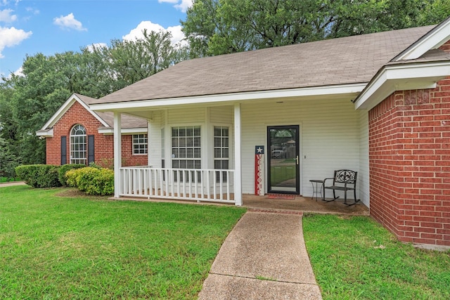 519 Kristi St, Robinson, TX 76706 - view of front of home with covered porch, a front lawn, roof with shingles, and brick siding