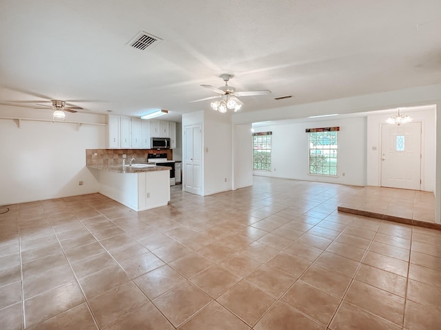 220 Hampton Ave, Corsicana, TX 75110 - unfurnished living room with ceiling fan and light tile patterned floors