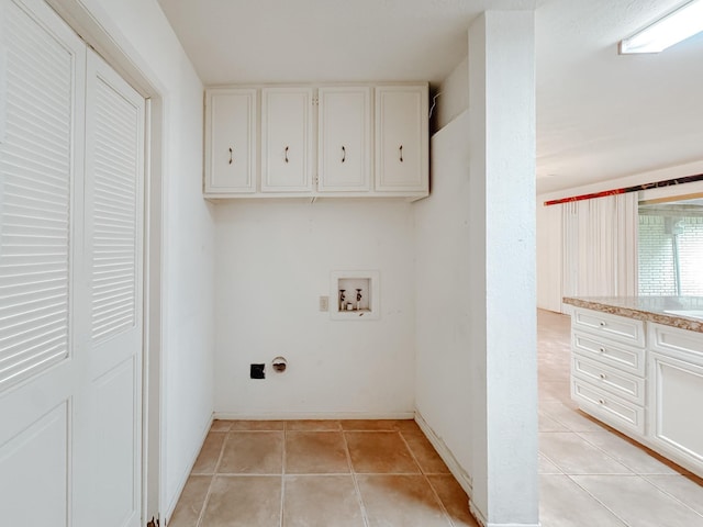 220 Hampton Ave, Corsicana, TX 75110 - washroom with washer hookup, light tile patterned flooring, and cabinet space