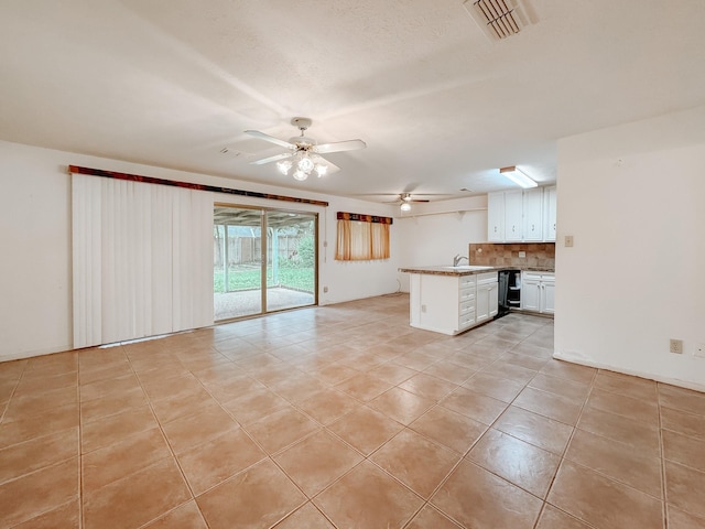 220 Hampton Ave, Corsicana, TX 75110 - unfurnished living room featuring a ceiling fan and light tile patterned flooring