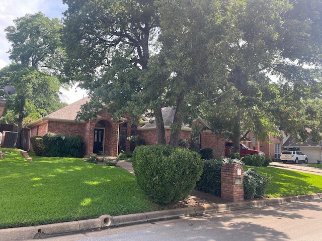 3406 Blue Forest Dr, Arlington, TX 76001 - obstructed view of property featuring brick siding and a front lawn