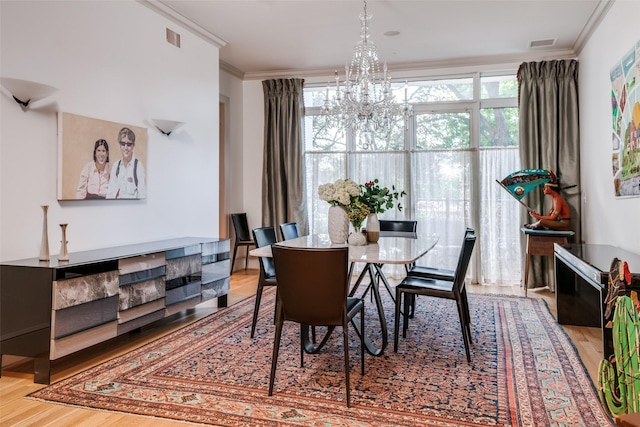 3505 Turtle Creek Blvd Unit 2A, Dallas, TX 75219 - dining room with a chandelier, crown molding, and wood finished floors