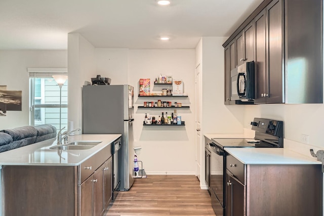 9263 Summerlee St, Dallas, TX 75227 - kitchen featuring black appliances, light wood finished floors, light countertops, dark brown cabinetry, and open floor plan