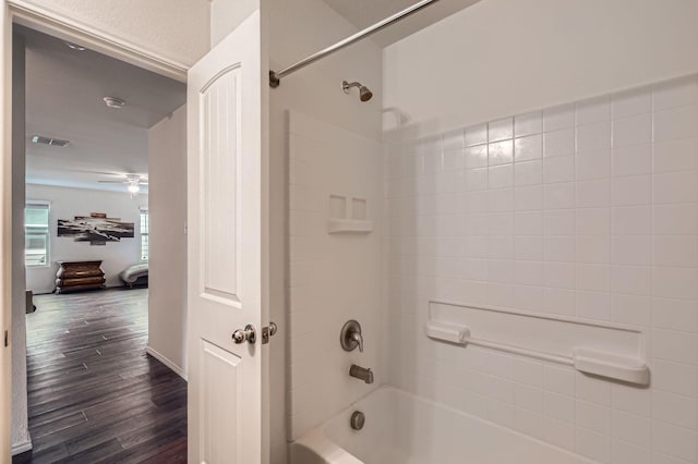 9263 Summerlee St, Dallas, TX 75227 - bathroom with  shower combination, wood finished floors, and a ceiling fan