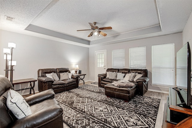 5307 Oak Branch Dr, Arlington, TX 76016 - living room with a tray ceiling, a ceiling fan, wood finished floors, and a textured ceiling