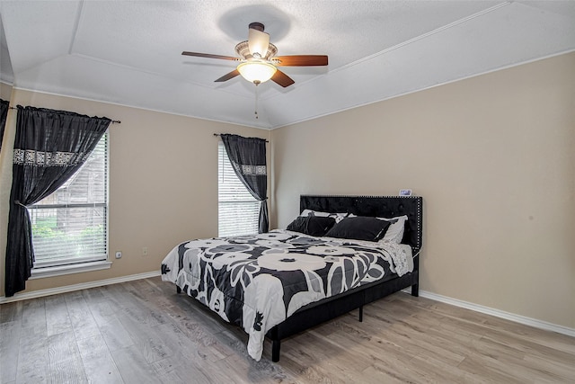 5307 Oak Branch Dr, Arlington, TX 76016 - bedroom with light wood-style flooring, lofted ceiling, a ceiling fan, and a textured ceiling