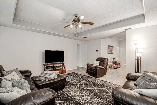 5307 Oak Branch Dr, Arlington, TX 76016 - living area with wood finished floors, a ceiling fan, a tray ceiling, and a textured ceiling