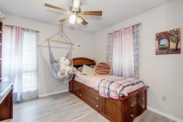 5307 Oak Branch Dr, Arlington, TX 76016 - bedroom with light wood-style floors, a ceiling fan, and a textured ceiling