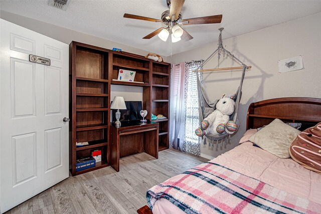 5307 Oak Branch Dr, Arlington, TX 76016 - bedroom featuring wood finished floors, a textured ceiling, and ceiling fan