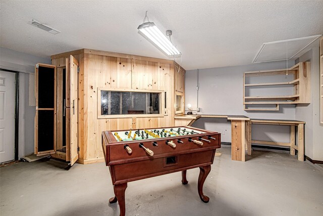 5307 Oak Branch Dr, Arlington, TX 76016 - playroom with attic access, concrete flooring, and a textured ceiling