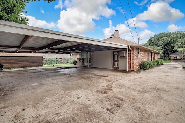 5307 Oak Branch Dr, Arlington, TX 76016 - view of property exterior with a carport, a chimney, brick siding, a wall mounted AC, and driveway