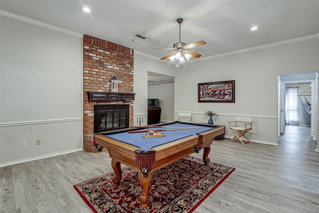 5307 Oak Branch Dr, Arlington, TX 76016 - recreation room with ornamental molding, light wood finished floors, billiards, a ceiling fan, and a brick fireplace