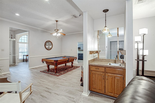 5307 Oak Branch Dr, Arlington, TX 76016 - kitchen with billiards table, light wood-style flooring, a textured ceiling, crown molding, and pendant lighting