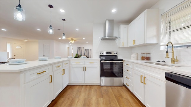 1608 Holt St, Fort Worth, TX 76103 - kitchen with stainless steel appliances, ventilation hood, light wood finished floors, light countertops, and white cabinets