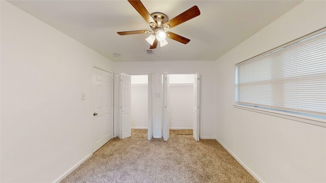 1608 Holt St, Fort Worth, TX 76103 - unfurnished bedroom featuring light colored carpet, multiple closets, and ceiling fan