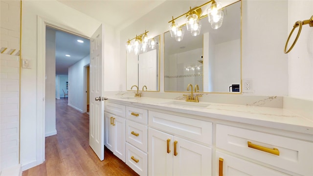 1608 Holt St, Fort Worth, TX 76103 - full bathroom with double vanity, wood finished floors, recessed lighting, and a shower