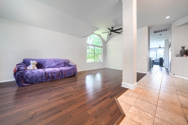 703 Monterey Dr, Rockwall, TX 75087 - living area featuring ornate columns, ceiling fan, light wood-style floors, and lofted ceiling