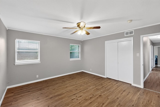 5417 Jane Anne St, Haltom City, TX 76117 - unfurnished bedroom with wood finished floors, ornamental molding, a closet, and ceiling fan