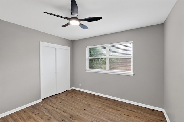 5417 Jane Anne St, Haltom City, TX 76117 - unfurnished bedroom with wood finished floors, a closet, and a ceiling fan
