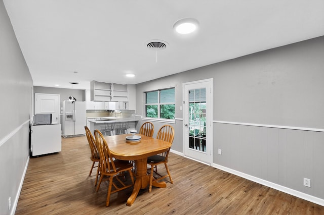 5417 Jane Anne St, Haltom City, TX 76117 - dining room featuring light wood-style flooring and wainscoting