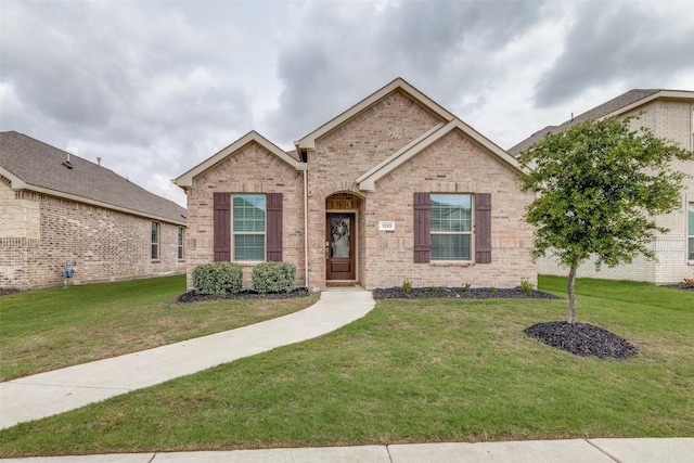 1233 Western Yarrow Ave, Justin, TX 76247 - traditional-style home featuring a front yard and brick siding