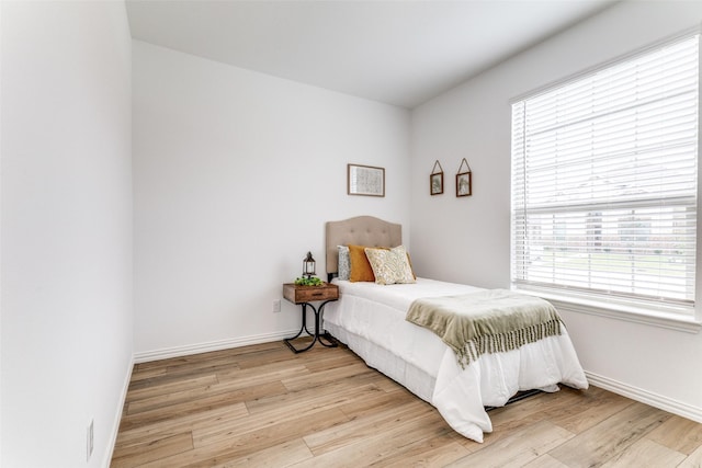 1233 Western Yarrow Ave, Justin, TX 76247 - bedroom with light wood-type flooring and multiple windows